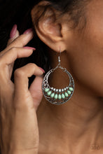 Load image into Gallery viewer, Filled with a silver filigree backdrop, an antiqued crescent frame is adorned with dainty opalescent rhinestones and Green Ash teardrop beads for a mystical finish. Earring attaches to a standard fishhook fitting.  Sold as one pair of earrings by Paparazzi. 
