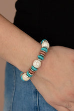 Load image into Gallery viewer, Disc shaped turquoise stones, white stones, and silvery beads join oversized white stone beads along a stretchy band, creating a rustic centerpiece around the wrist.
