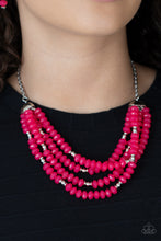 Load image into Gallery viewer, Featuring bold silver fittings, a whimsical collection of faceted pink opaque crystal-like beads and dainty silver beads are threaded along invisible wires below the collar, creating vivacious layers. Features an adjustable clasp closure.  Sold as one individual necklace. Includes one pair of matching earrings. 
