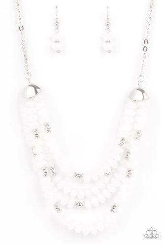 Featuring bold silver fittings, a whimsical collection of faceted white opaque crystal-like beads and dainty silver beads are threaded along invisible wires below the collar, creating icy layers. Features an adjustable clasp closure.  Sold as one individual necklace. Includes one pair of matching earrings.