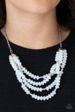 Load image into Gallery viewer, Featuring bold silver fittings, a whimsical collection of faceted white opaque crystal-like beads and dainty silver beads are threaded along invisible wires below the collar, creating icy layers. Features an adjustable clasp closure.  Sold as one individual necklace. Includes one pair of matching earrings.
