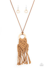 Load image into Gallery viewer, Crafty Couture - Paparazzi - Strands of brown yarn-like thread delicately weaves into a knotted macrame pattern at the bottom of a white wooden hoop. Dainty strands of brown suede knot around the pendant for an earthy flair.
