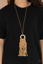 Load image into Gallery viewer, Crafty Couture - Paparazzi - Strands of brown yarn-like thread delicately weaves into a knotted macrame pattern at the bottom of a white wooden hoop. Dainty strands of brown suede knot around the pendant for an earthy flair.
