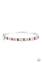 Load image into Gallery viewer, Toast To Twinkle - Paparazzi - Featuring regal emerald style cuts, a dainty row of pink, white and iridescent rhinestones are encrusted across the front of a silver cuff-like bangle for a timeless fashion. Features a hinged closure.
