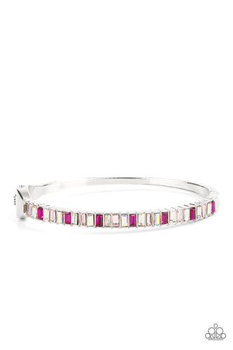 Toast To Twinkle - Paparazzi - Featuring regal emerald style cuts, a dainty row of pink, white and iridescent rhinestones are encrusted across the front of a silver cuff-like bangle for a timeless fashion. Features a hinged closure.