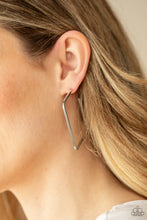 Load image into Gallery viewer, A deceptively simple square frame is tilted on point to create a geometric hoop. Its sharp angles are complemented by its shiny silver finish, making a lasting impression. Earring attaches to a standard post fitting. Hoop measures approximately 2&quot; in diameter.  Sold as one pair of hoop earrings by Paparazzi.
