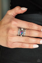 Load image into Gallery viewer, The GLEAMING Tower - Purple - A gleaming oval cut gem sits atop a silver bar with smaller white rhinestones resting on either side. Silver bars etched in floral detail on top and bottom create a towering effect across the finger. Features a stretchy band for a flexible fit
