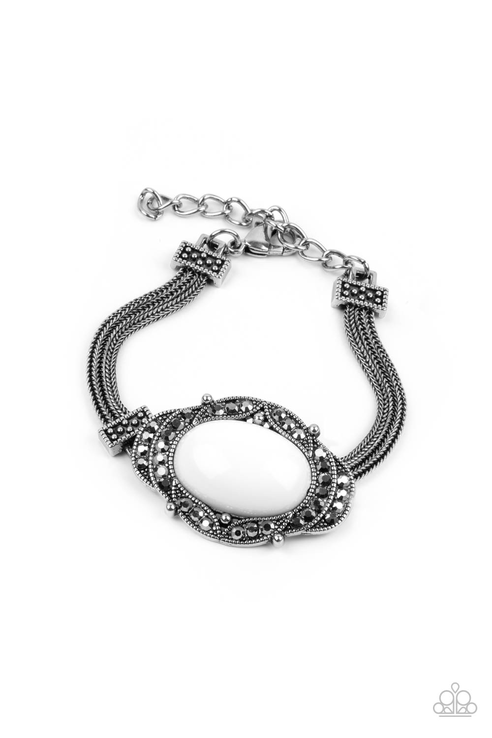Hematite encrusted silver frames delicately overlap around an oval white bead, creating an edgy centerpiece. The colorful centerpiece attaches to strands of ornate silver chains that are held in place around the wrist by studded silver frames. Features an adjustable clasp closure.
