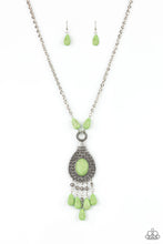 Load image into Gallery viewer, Paparazzi - Cowgirl Couture - Green - An Apple Green oval stone sits center stage surrounded by swirly designs stamped into a wide silver frame. A fringe of silver floral beads culminating in Apple Green stones swings like a pendulum at the end of a lengthened silver chain for a fashionable finish.
