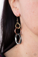 Load image into Gallery viewer, Featuring an antiqued beveled center, warped brass, copper, and silver rings asymmetrically connect into a rustic lure. Earring attaches to a standard fishhook fitting.
