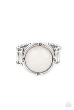 Load image into Gallery viewer, A glassy white stone bead is pressed into the center of a silver frame featuring a distressed border, creating an ethereal display atop the finger. Features a stretchy band for a flexible fit.
