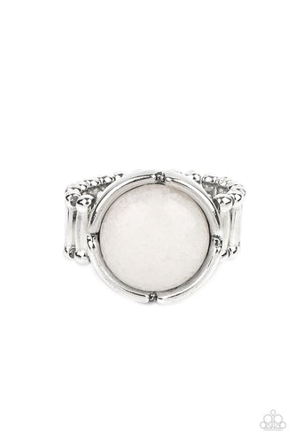 A glassy white stone bead is pressed into the center of a silver frame featuring a distressed border, creating an ethereal display atop the finger. Features a stretchy band for a flexible fit.