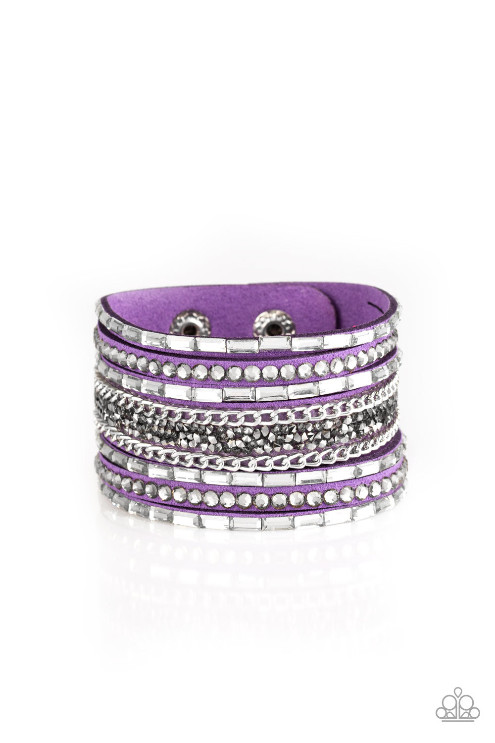 White emerald-cut rhinestones, smoky round rhinestones, and metallic prism-shaped rhinestones are sprinkled along strands of vivacious purple suede. Shimmery silver chain is added to the mix for a sassy industrial finish. Features an adjustable snap closure.