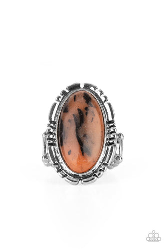 Peacefully Pioneer - Paparazzi - An earthy brown oval stone is pressed into the center of a textured silver frame, creating an abstract artisanal display atop the finger. Features a stretchy band for a flexible fit.