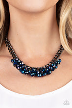 Load image into Gallery viewer, Galactic Knockout - Paparazzi - A faceted collection of metallic flecked blue beads cluster along the center of a chunky gunmetal curb chain, creating a stellar fringe below the collar.
