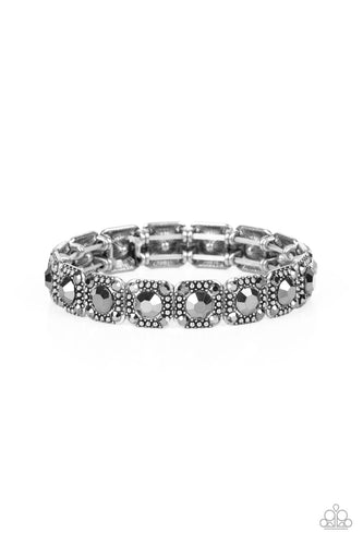 Cache Commodity - Silver - Dotted with oversized hematite rhinestone centers, the corners of silver studded frames are adorned in dainty hematite rhinestones as they glide along stretchy bands around the wrist for a sassy sparkle.