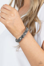 Load image into Gallery viewer, Cache Commodity - Silver - Dotted with oversized hematite rhinestone centers, the corners of silver studded frames are adorned in dainty hematite rhinestones as they glide along stretchy bands around the wrist for a sassy sparkle.
