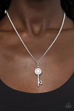 Load image into Gallery viewer, Paparazzi - Prized Key Player - Pink - Bordered in glassy white rhinestones, an opal pink rhinestone adorns a shiny silver key pendant at the bottom of a dainty silver chain for a whimsical fashion.
