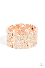 Load image into Gallery viewer, Paparazzi - Wheeling and Dealing - Rose Gold - Dotted with sections of glassy white rhinestones, an immaculate display of studded wheel and floral rose gold patterns combines into shimmering frames along stretchy bands around the wrist for a regal flair.
