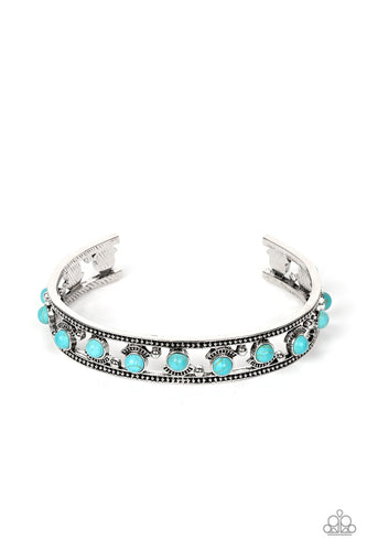 Paparazzi - Badlands Bliss - Blue - Seemingly floating inside the center of a studded silver cuff, dainty turquoise stone beads are fitted in place with shiny silver studs and textured silver frames that alternate along the top and bottom of the stone pieces for an artisan inspired fashion.