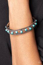 Load image into Gallery viewer, Paparazzi - Badlands Bliss - Blue - Seemingly floating inside the center of a studded silver cuff, dainty turquoise stone beads are fitted in place with shiny silver studs and textured silver frames that alternate along the top and bottom of the stone pieces for an artisan inspired fashion.
