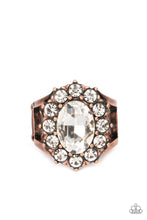 Load image into Gallery viewer, Paparazzi - Moxie Magic - Copper -  A dauntless oval rhinestone is encircled by dainty sparkling gems. Accented with petite antiqued copper studs, the dramatic design joins with an airy layered copper band to create a captivating arrangement atop the finger.
