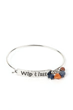 Load image into Gallery viewer, Paparazzi - Fearless Fashionista - Blue - The words &quot;Wild &amp; Free&quot; are stamped across a thick plate of silver in a playful font. An orange stone and two lapis stones combine with a brown wooden bead, gathering at the side of the inspirational centerpiece as it connects to a skinny silver bar that wraps around the wrist.
