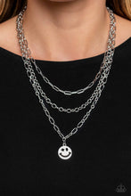 Load image into Gallery viewer, Winking Wanderer - Silver - A trio of silver paperclip, classic, and oval link chains coalesces down the neckline for a monochromatic masterpiece. Strung on the lowermost oval link chain, a silver smiley face pendant, with a star mimicking a wink for one of its eyes, stands out and reflects light in every direction for a statement finish.  Paparazzi Accessories
