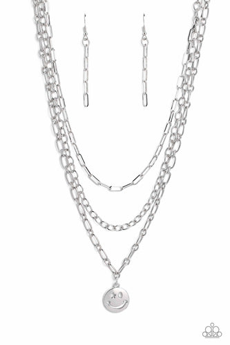 Paparazzi - Winking Wanderer - Silver - A trio of silver paperclip, classic, and oval link chains coalesces down the neckline for a monochromatic masterpiece. Strung on the lowermost oval link chain, a silver smiley face pendant, with a star mimicking a wink for one of its eyes, stands out and reflects light in every direction for a statement finish.