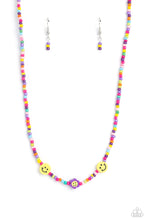 Load image into Gallery viewer, Paparazzi - Flower Power Pageant - Purple - Multicolored seed beads, featuring lavender, green, pink, pearly pink, blue, orange, purple, yellow, and dark green, are threaded along a wire, falling along the collar in a capricious pattern. Bringing additional charm to the design, yellow smiley face beads, and a purple flower with a yellow smiley face center, blooms amongst the bright pops of color. 
