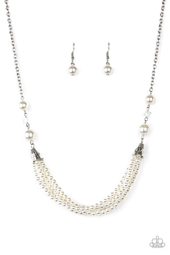 Oversized white pearls and crystal-like beads give way to layers of beaded pearl strands below the collar for a timeless look. Features an adjustable clasp closure.